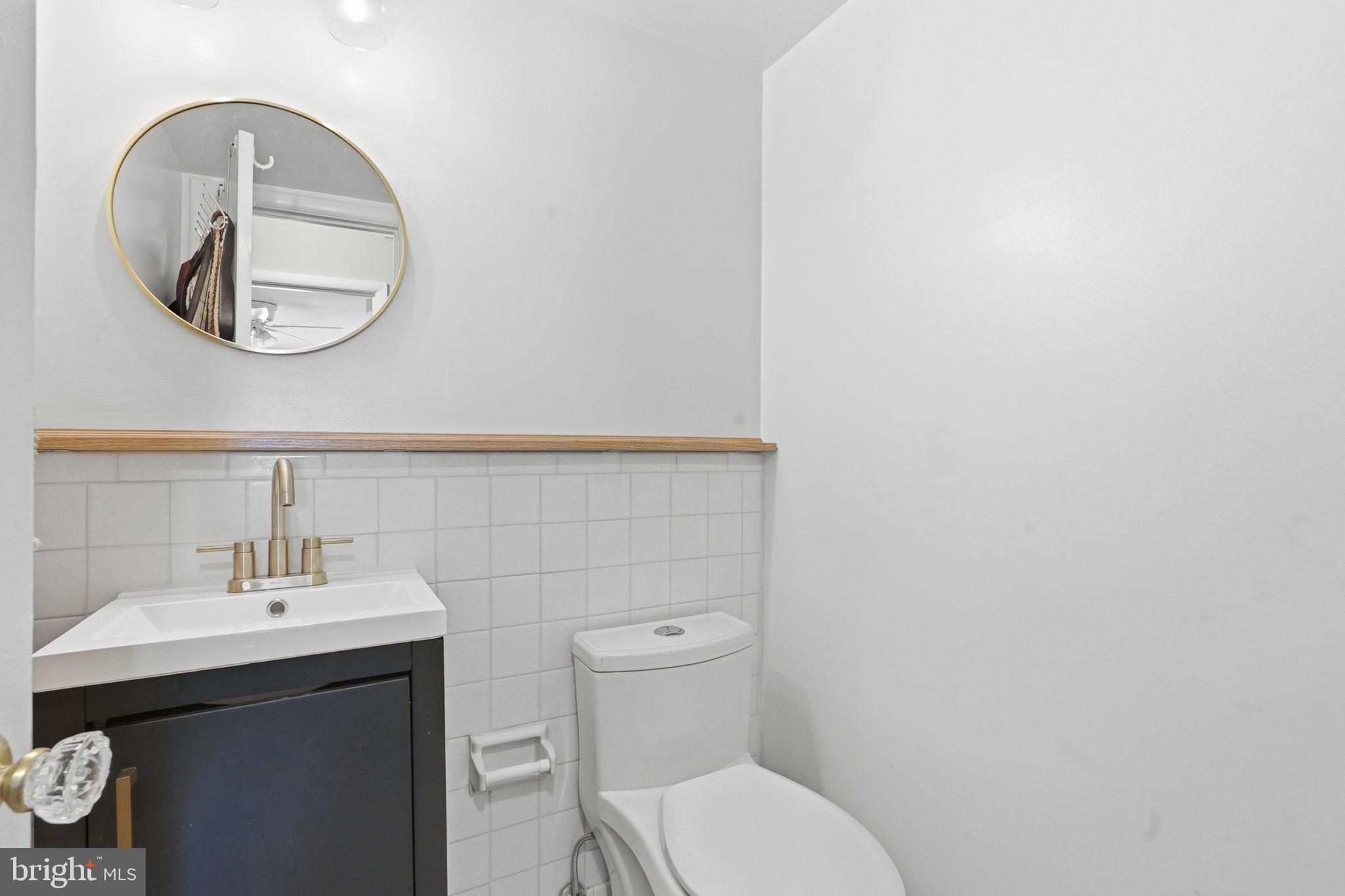 5017 7th Road South, Unit 102 Arlington, VA 22204 - Photo 23 of 40 a bathroom with a toilet a sink and a mirror