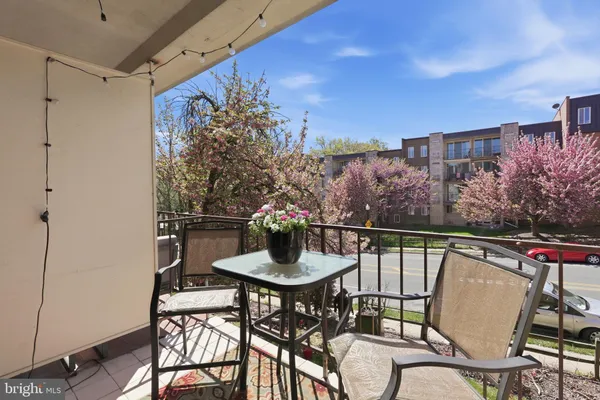 a balcony with table and chairs