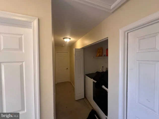 an empty room with closet and a chandelier fan