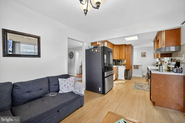 a living room with furniture and kitchen view