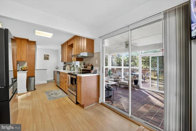 a kitchen with stainless steel appliances a stove top oven and a refrigerator