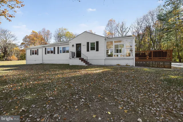 a front view of a house with a garden and yard