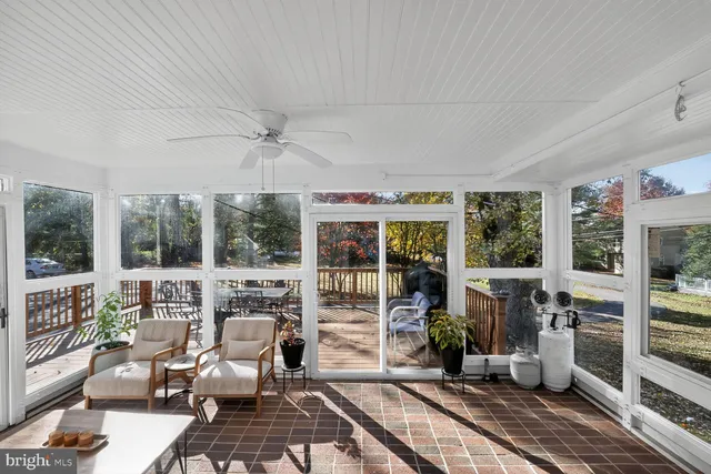 a living room with furniture and large windows