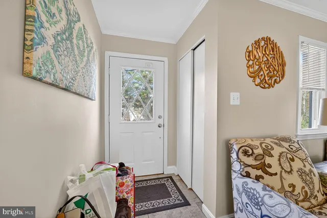 a room with a wall paintings and a window