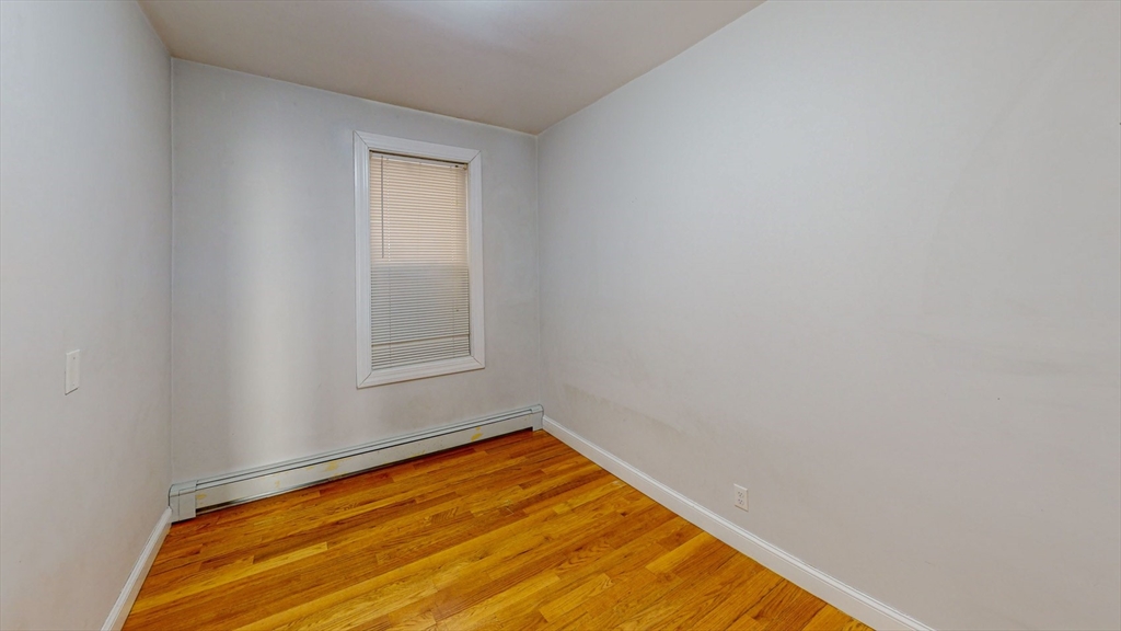 67 Marion Street, Unit 2 Boston, MA 02128 - Photo 11 of 15 a view of a room with a wooden floor and a window