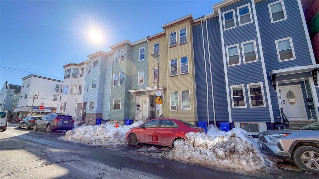 67 Marion Street, Unit 2 Boston, MA 02128 - Photo 13 of 15 a front view of a building with street