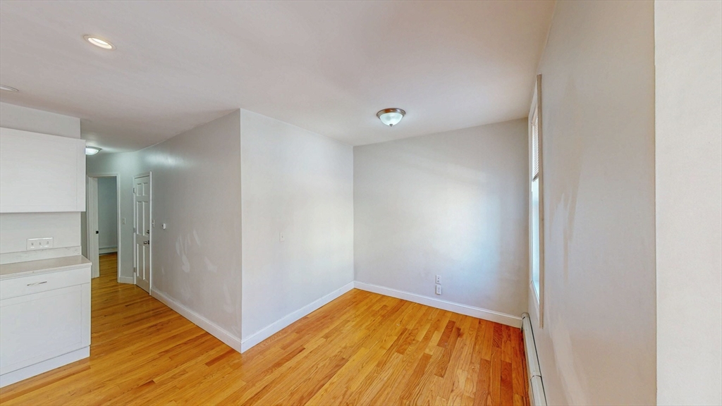 67 Marion Street, Unit 2 Boston, MA 02128 - Photo 6 of 15 a view of empty room with wooden floor