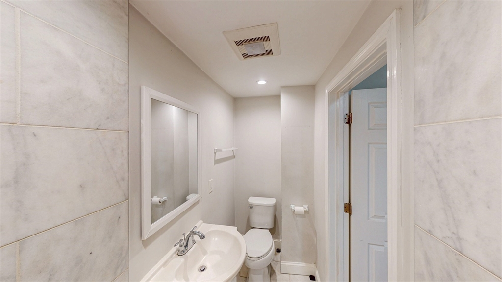 67 Marion Street, Unit 2 Boston, MA 02128 - Photo 7 of 15 a bathroom with a toilet a sink and shower