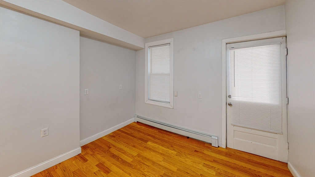67 Marion Street, Unit 2 Boston, MA 02128 - Photo 9 of 15 a view of empty room with wooden floor
