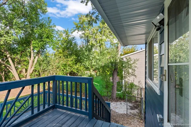 a view of a wooden balcony with a tree