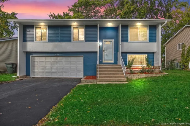 a front view of a house with a yard and garage