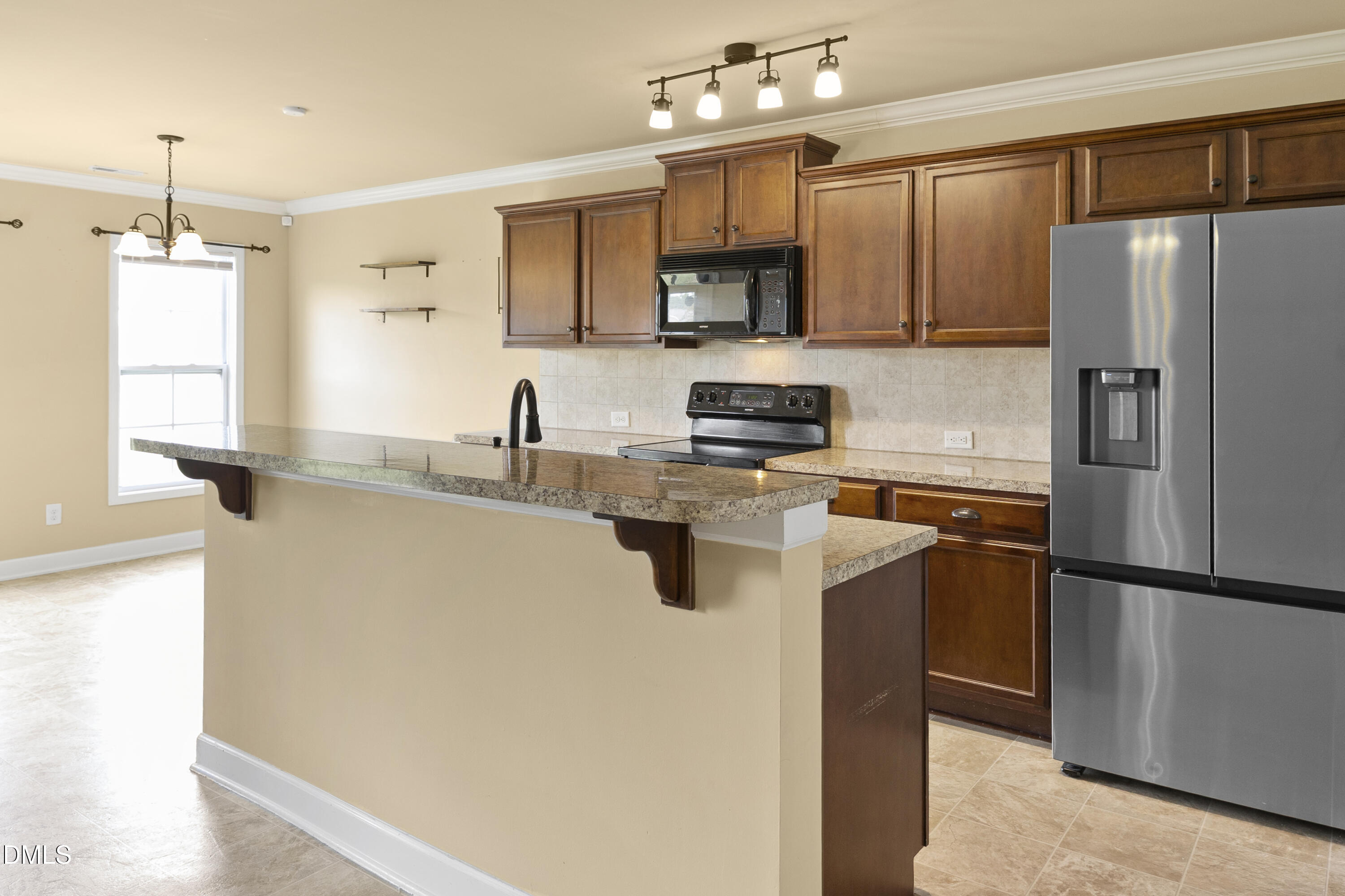 298 Declaration Drive Raeford, NC 28376 - Photo 40 of 58 a kitchen with stainless steel appliances granite countertop a refrigerator a sink a stove a microwave and cabinets