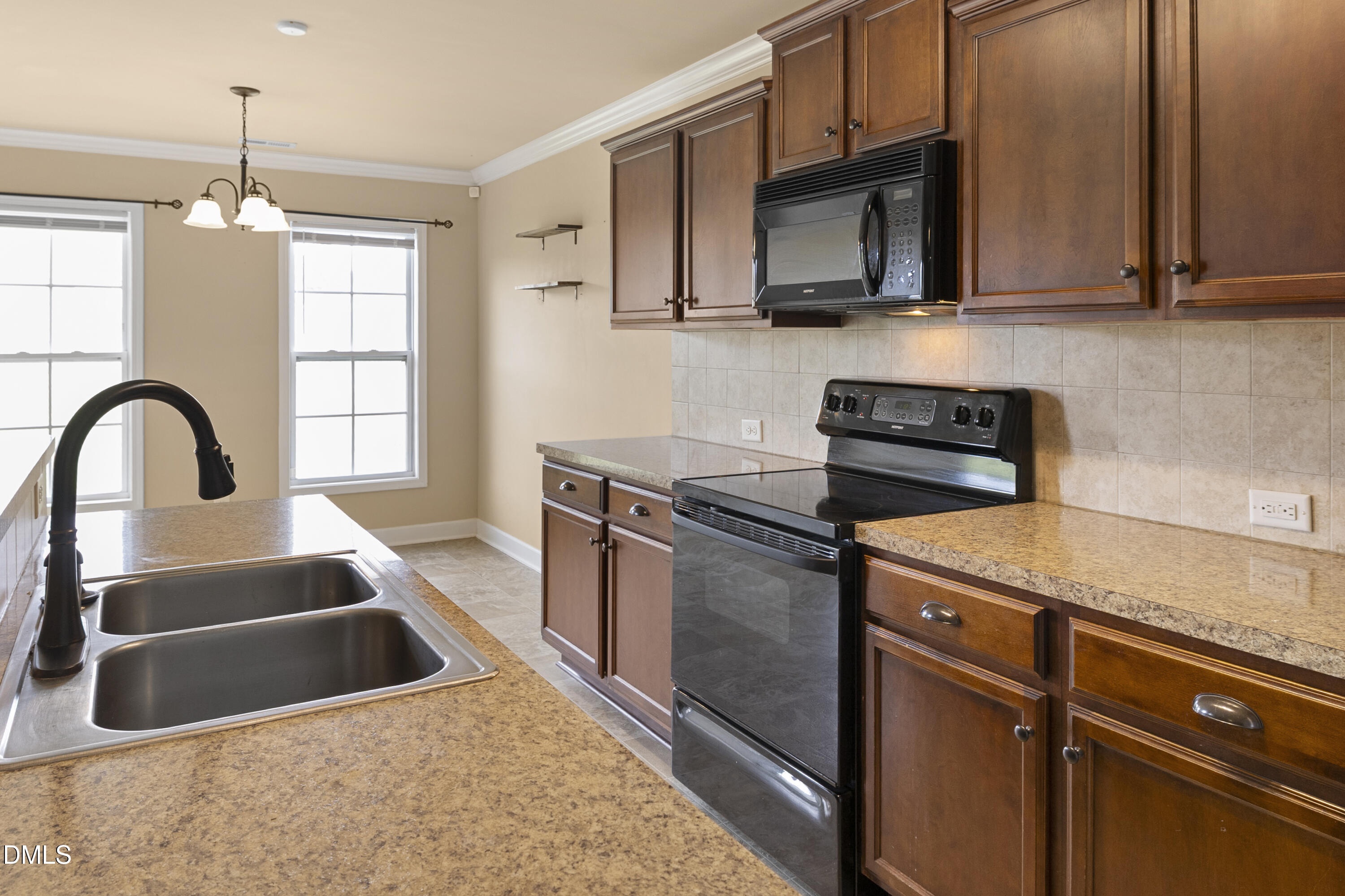 298 Declaration Drive Raeford, NC 28376 - Photo 41 of 58 a kitchen with granite countertop a sink stainless steel appliances and cabinets
