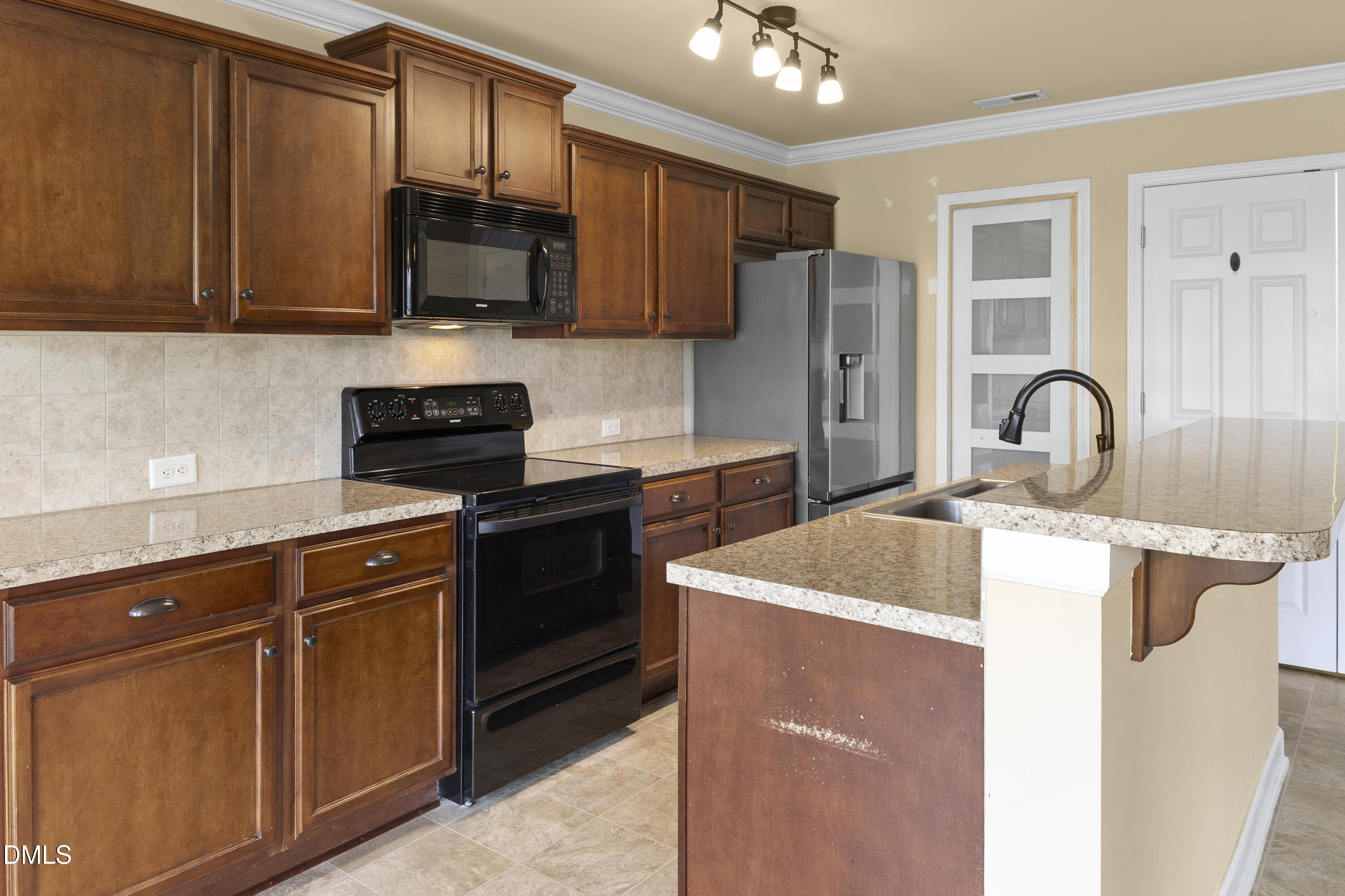 298 Declaration Drive Raeford, NC 28376 - Photo 42 of 58 a kitchen with stainless steel appliances granite countertop a sink stove and refrigerator