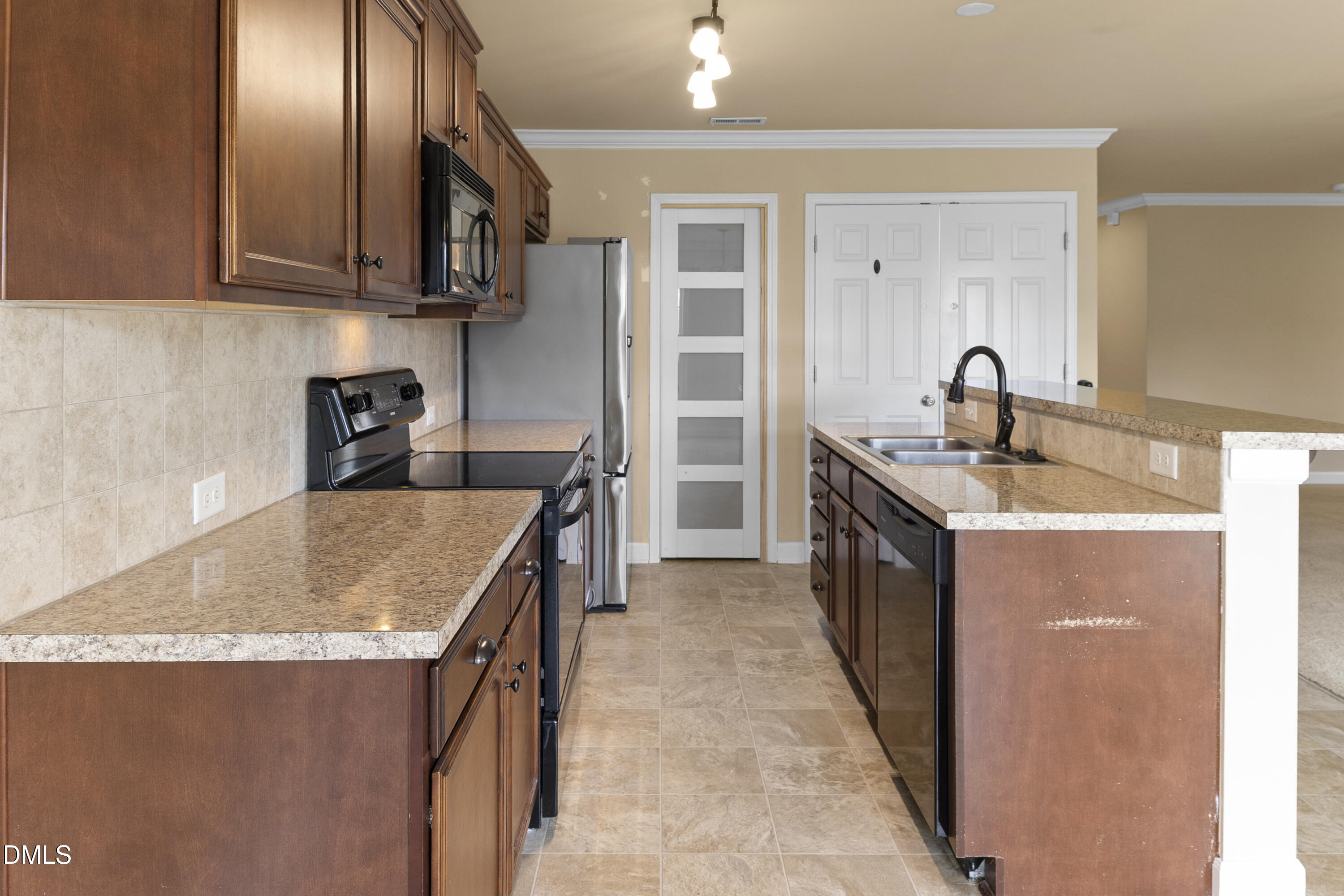298 Declaration Drive Raeford, NC 28376 - Photo 43 of 58 a kitchen with stainless steel appliances granite countertop a sink stove and refrigerator