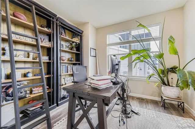 a view of a dining room with furniture and a book shelf