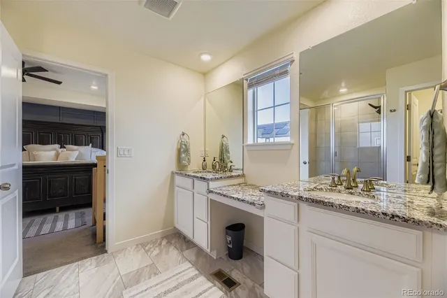 a bathroom with a sink double vanity and a shower