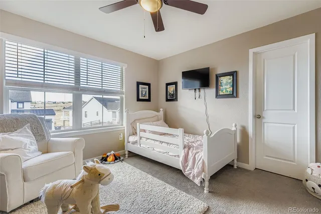 a bedroom with furniture and a large window