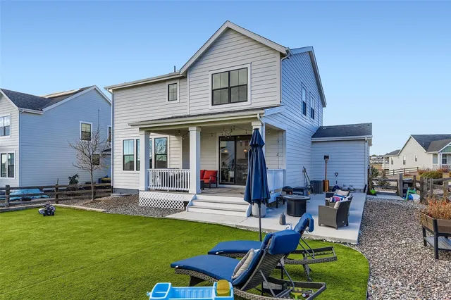 a view of a house with backyard porch and sitting area