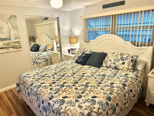 a bed sitting in a bedroom next to a window