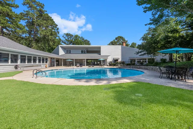 a view of a house with a yard patio and swimming pool