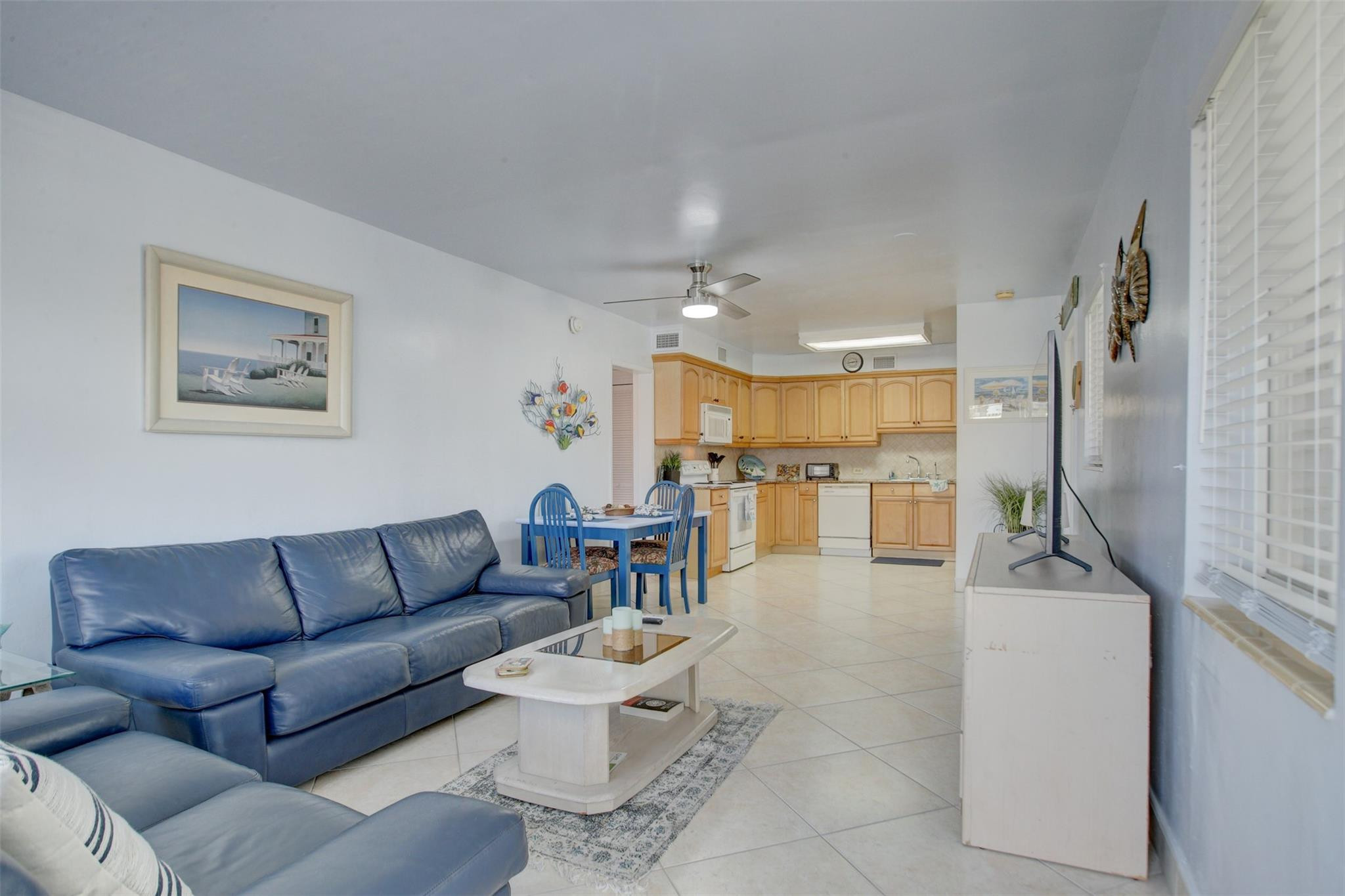999 North Riverside Drive, Unit 11 Pompano Beach, FL 33062 - Photo 5 of 12 a living room with furniture and a view of kitchen