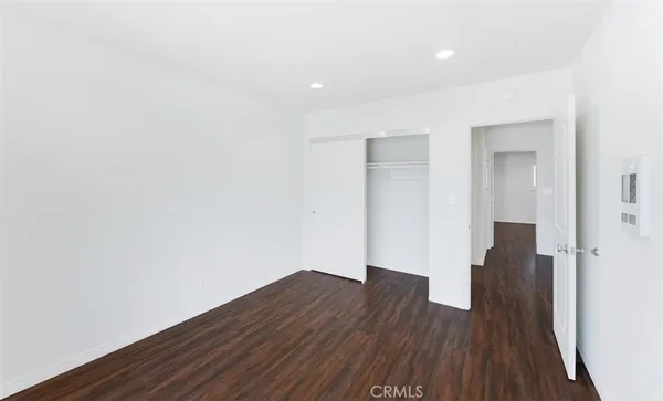 wooden floor in a hall with an empty room and wooden floor