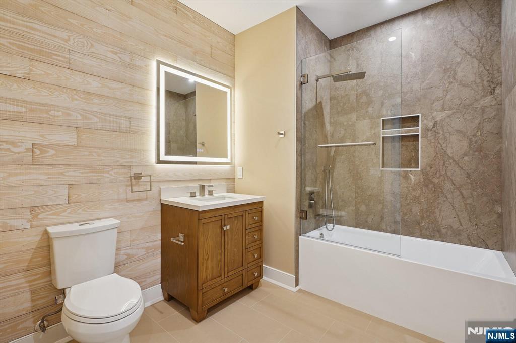 108 Montgomery Street Bloomfield, NJ 07003 - Photo 12 of 31 a bathroom with a sink a toilet and shower