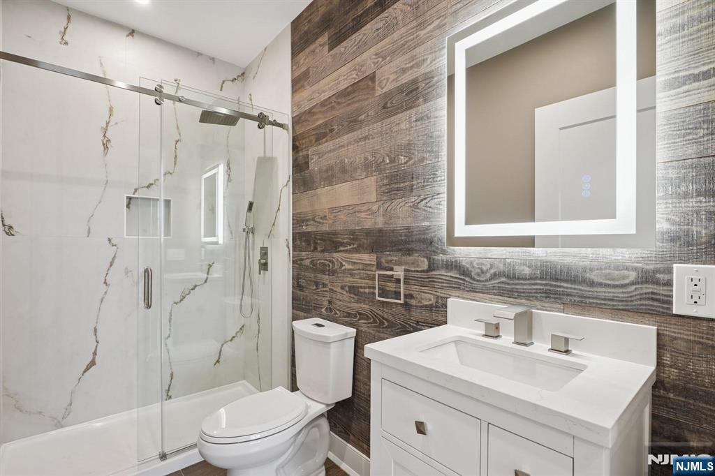 108 Montgomery Street Bloomfield, NJ 07003 - Photo 13 of 31 a bathroom with a sink toilet vanity and shower