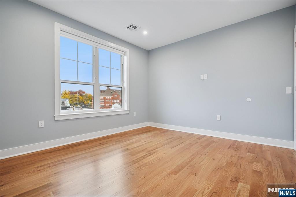 108 Montgomery Street Bloomfield, NJ 07003 - Photo 14 of 31 a view of an empty room with window and wooden floor