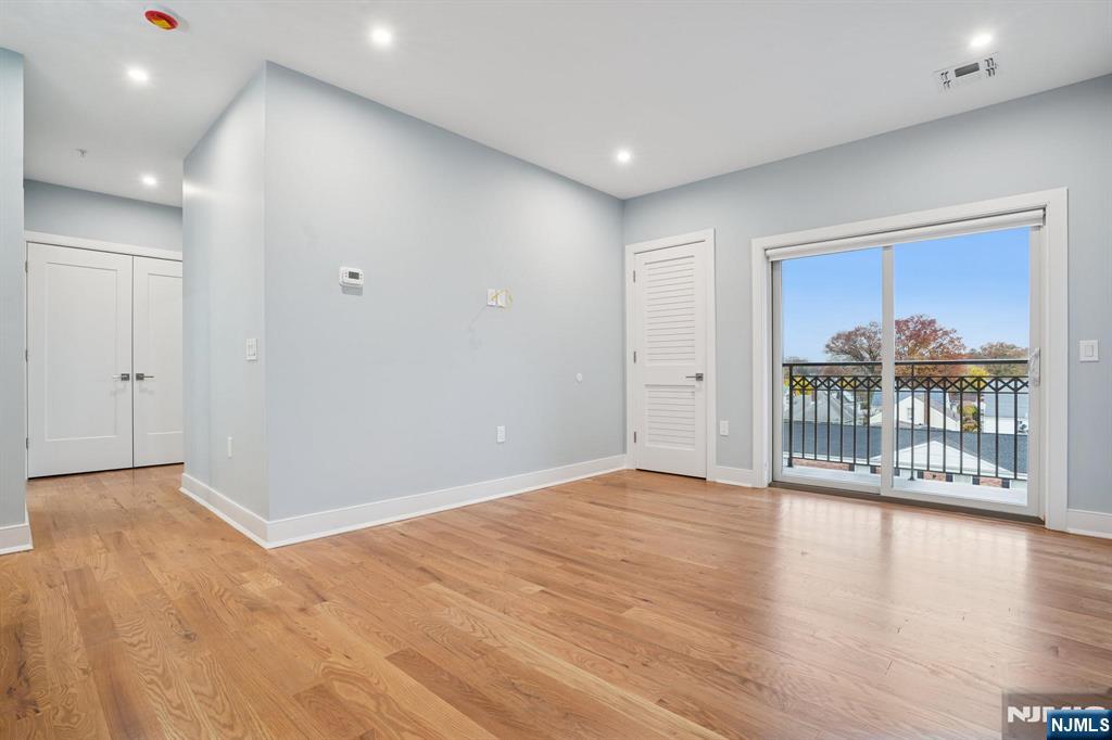 108 Montgomery Street Bloomfield, NJ 07003 - Photo 15 of 31 a view of an empty room with wooden floor and a window
