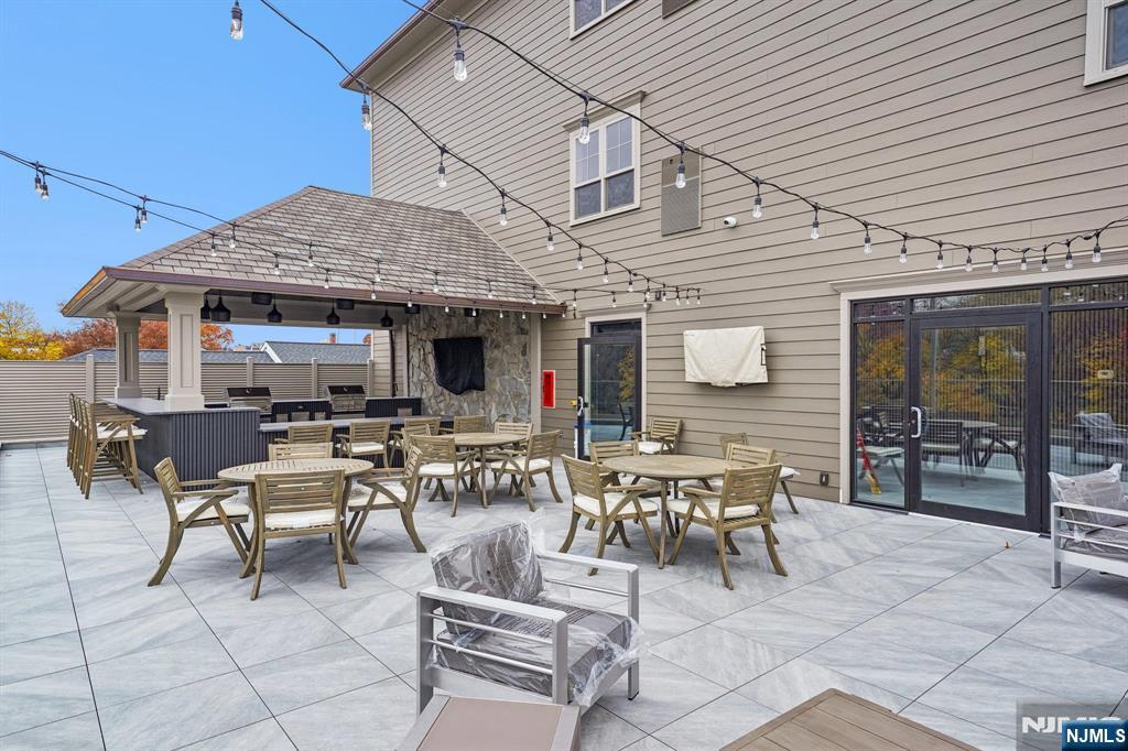 108 Montgomery Street Bloomfield, NJ 07003 - Photo 24 of 31 a view of a patio with table and chairs and a barbeque