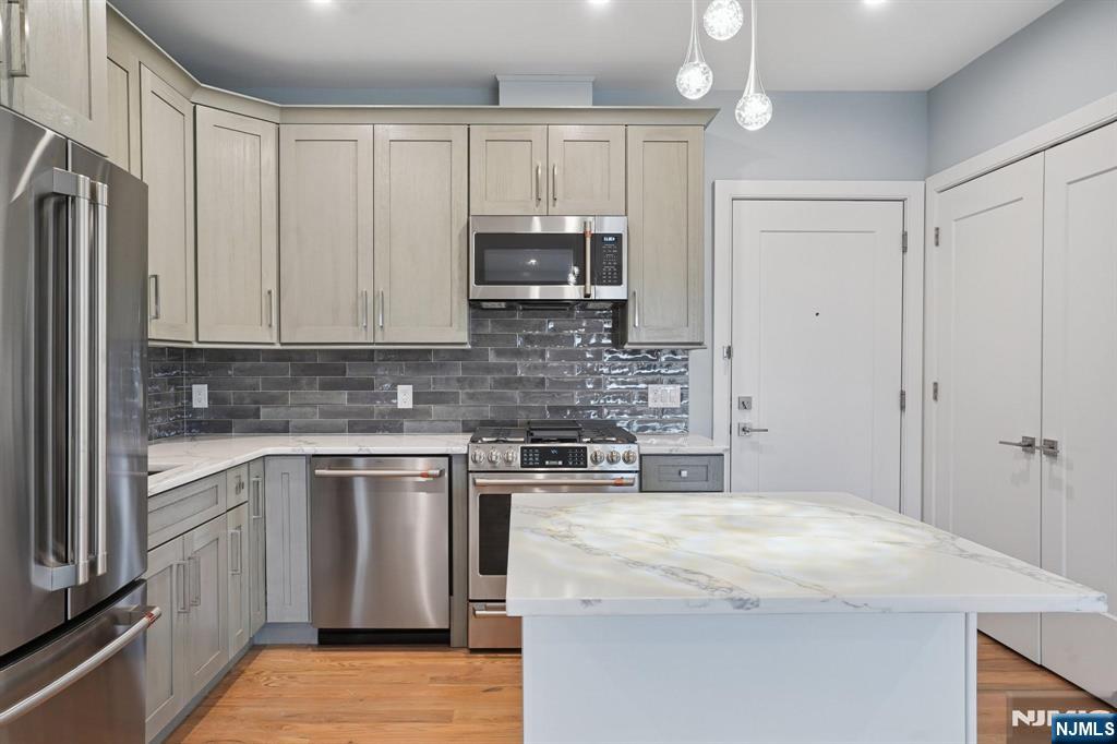 108 Montgomery Street Bloomfield, NJ 07003 - Photo 5 of 31 a kitchen with stainless steel appliances granite countertop a stove a sink and a refrigerator