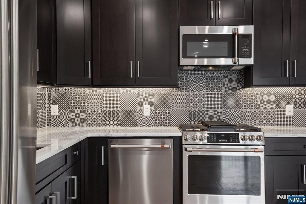108 Montgomery Street Bloomfield, NJ 07003 - Photo 7 of 31 a kitchen with a stove and a microwave