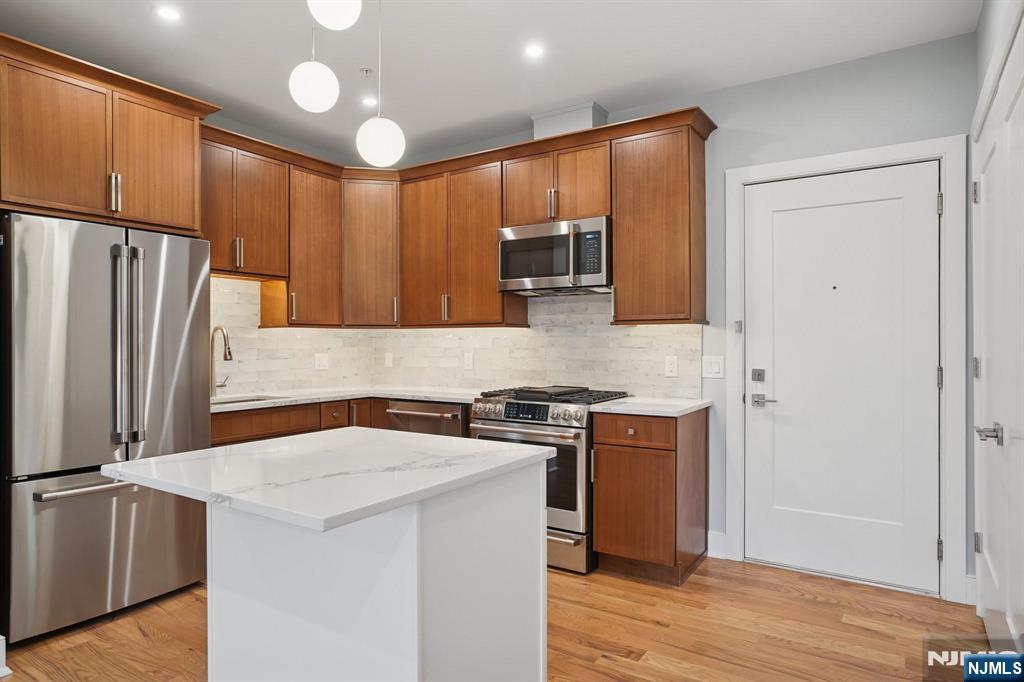 108 Montgomery Street Bloomfield, NJ 07003 - Photo 8 of 31 a kitchen with stainless steel appliances granite countertop a refrigerator stove and sink
