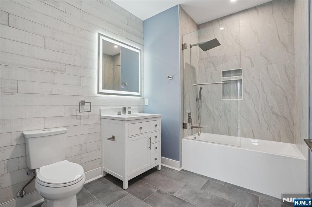 108 Montgomery Street Bloomfield, NJ 07003 - Photo 10 of 31 a bathroom with a granite countertop sink toilet and shower