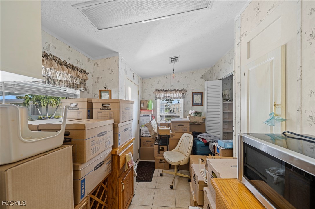 370 Nicklaus Boulevard North Fort Myers, FL 33903 - Photo 19 of 30 a view of a kitchen with fridge and wooden floor