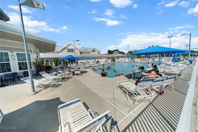 a view of a house with a big yard and large trees