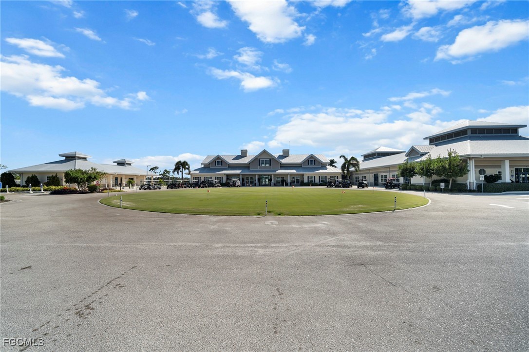 370 Nicklaus Boulevard North Fort Myers, FL 33903 - Photo 26 of 30 a view of a house with a big yard and large trees