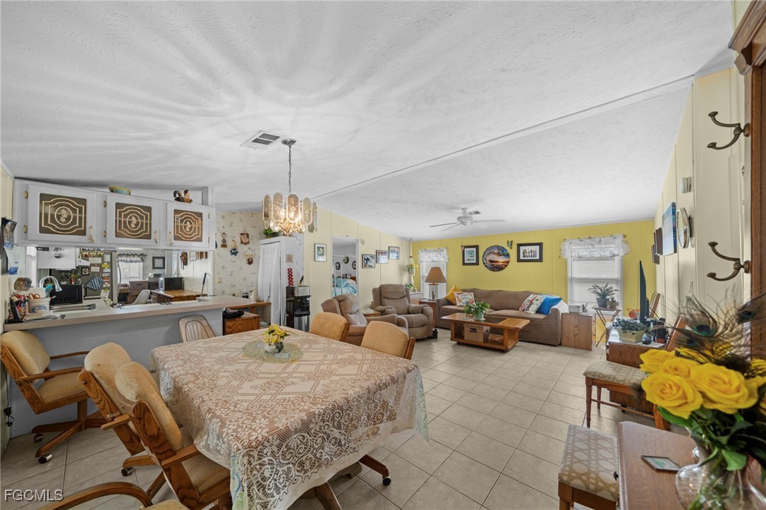 370 Nicklaus Boulevard North Fort Myers, FL 33903 - Photo 7 of 30 a living room with furniture and a chandelier