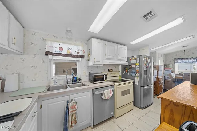 a kitchen with stainless steel appliances kitchen island granite countertop a sink and cabinets