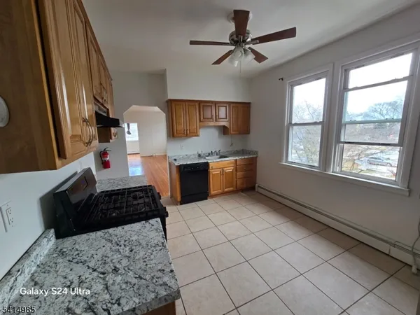 a kitchen with stainless steel appliances a stove a sink and a refrigerator