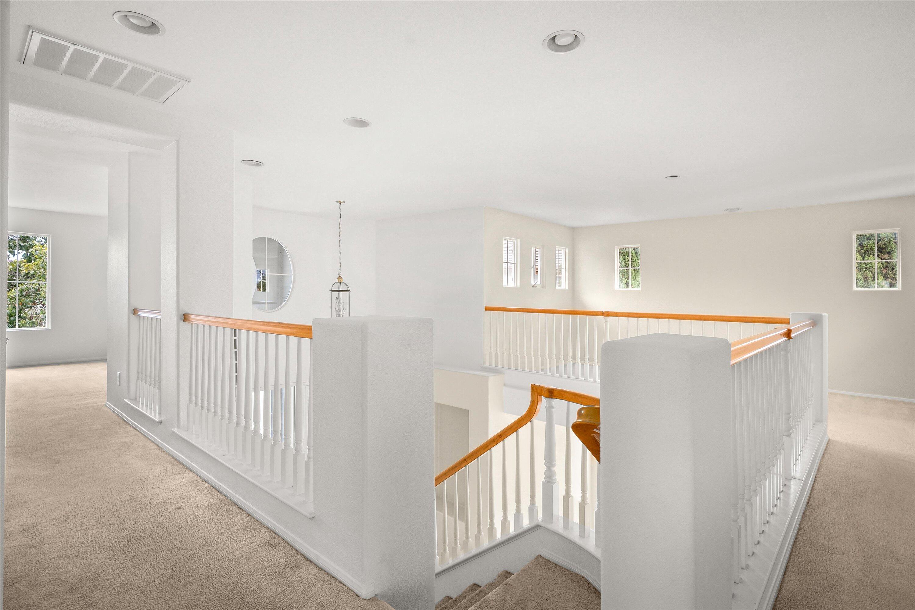 458 Greenleaf Court Goleta, CA 93117 - Photo 11 of 34 a view of a hallway with windows and stairs