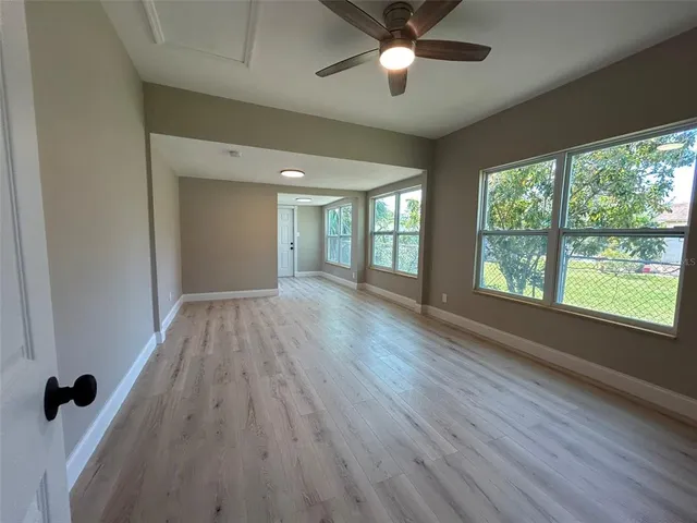 wooden floor in an empty room with a window