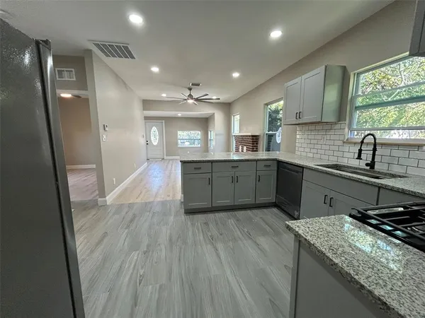 a kitchen with sink and window