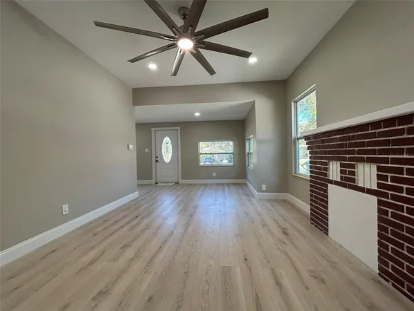 wooden floor in an empty room with a window
