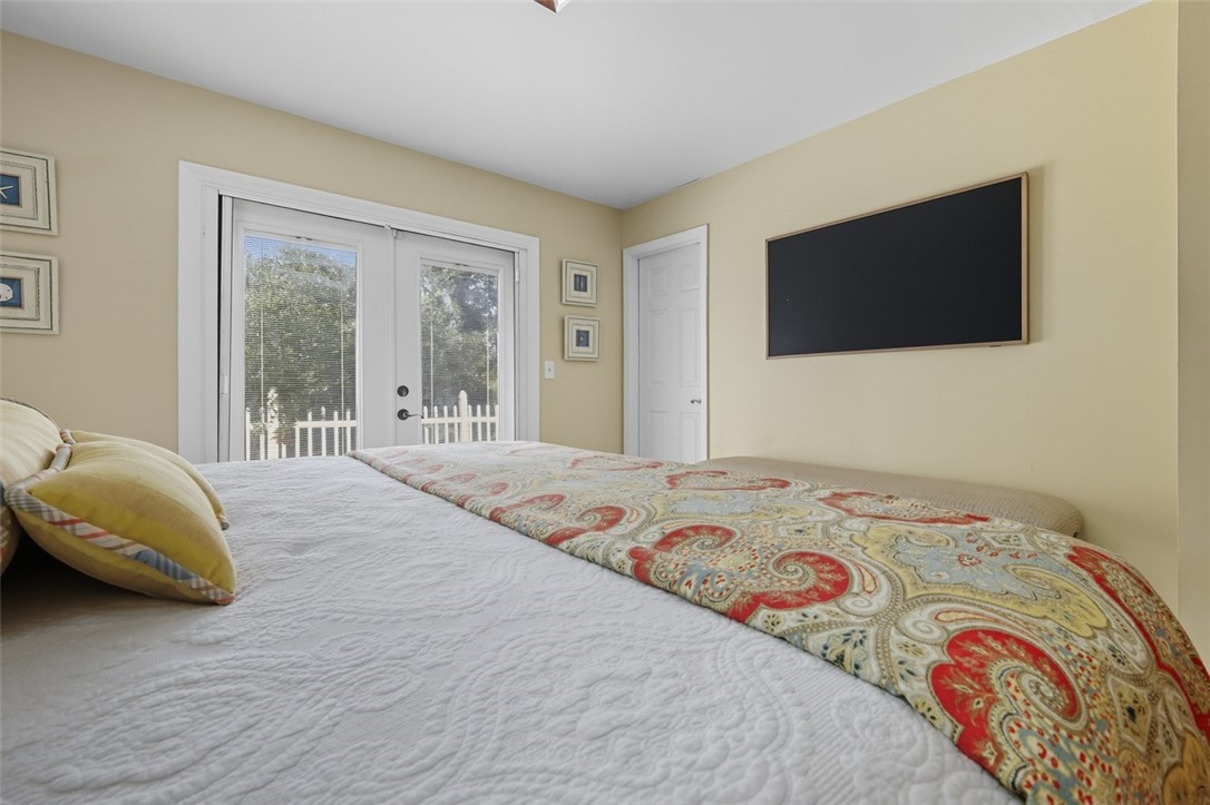 902 Tides Road Vero Beach, FL 32963 - Photo 14 of 25 a bedroom with a bed and a flat screen tv