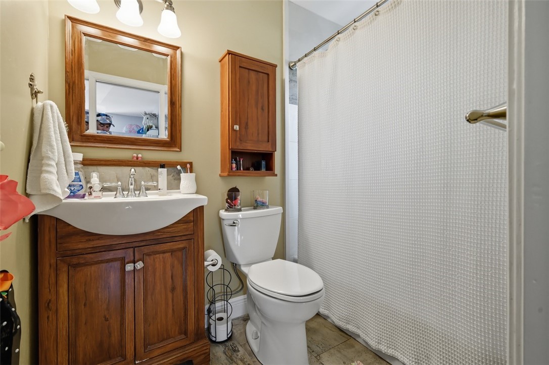 902 Tides Road Vero Beach, FL 32963 - Photo 17 of 25 a bathroom with a sink a toilet and mirror