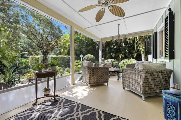 a dining room with furniture water view and a floor to ceiling window
