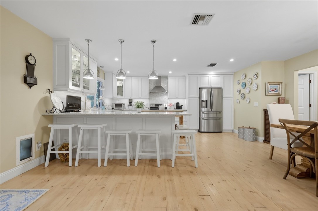 902 Tides Road Vero Beach, FL 32963 - Photo 2 of 25 a large kitchen with a table and chairs